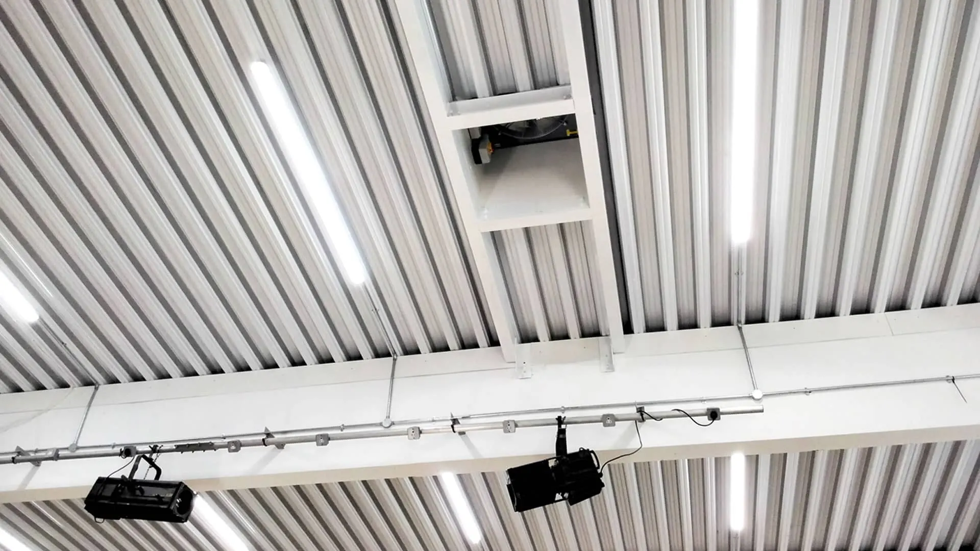 Roof structure inside a school sports hall after RAAC panels were replaced with a new metal deck