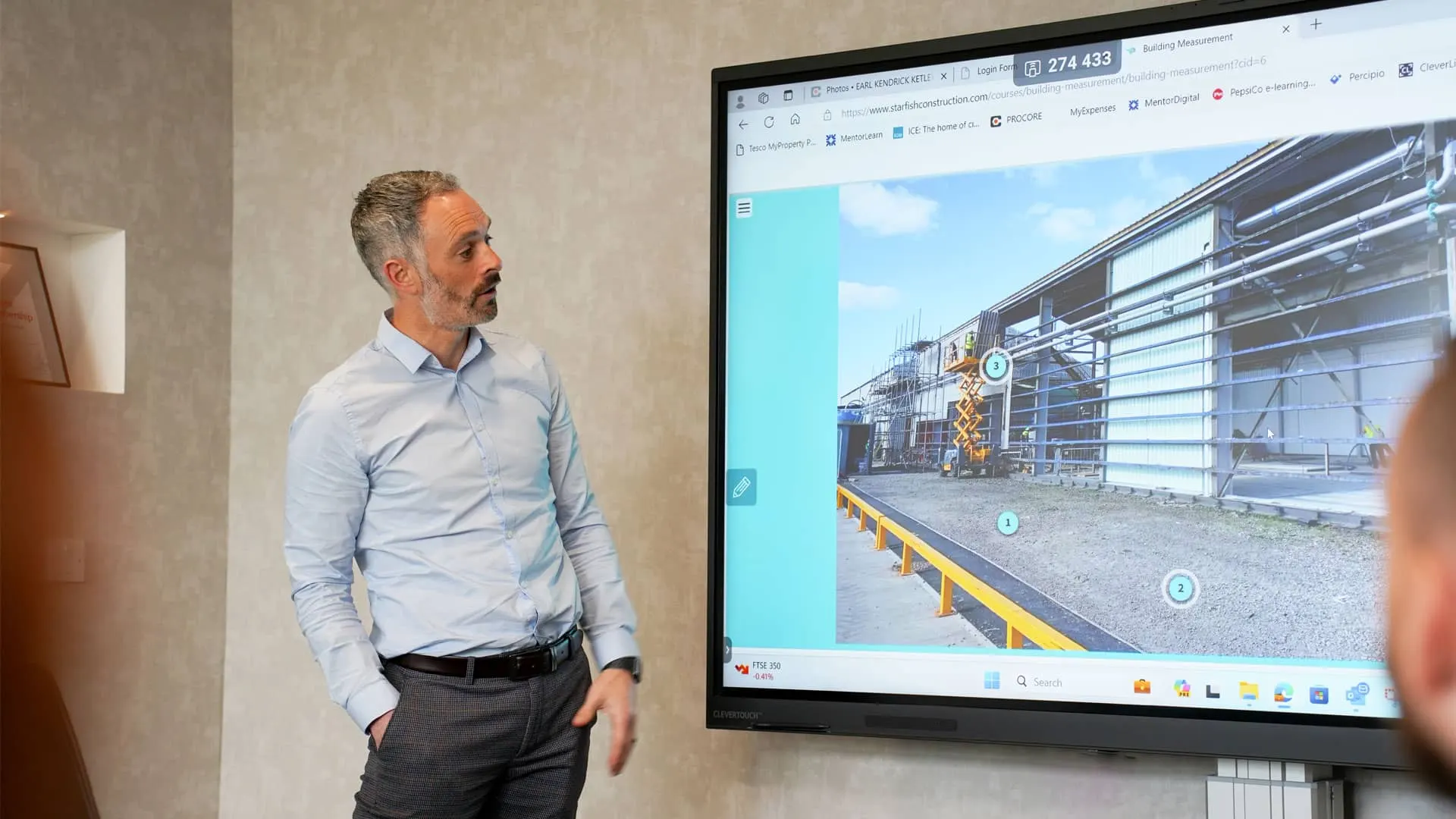 Starfish Construction team member presenting a 3D site scan in a project meeting