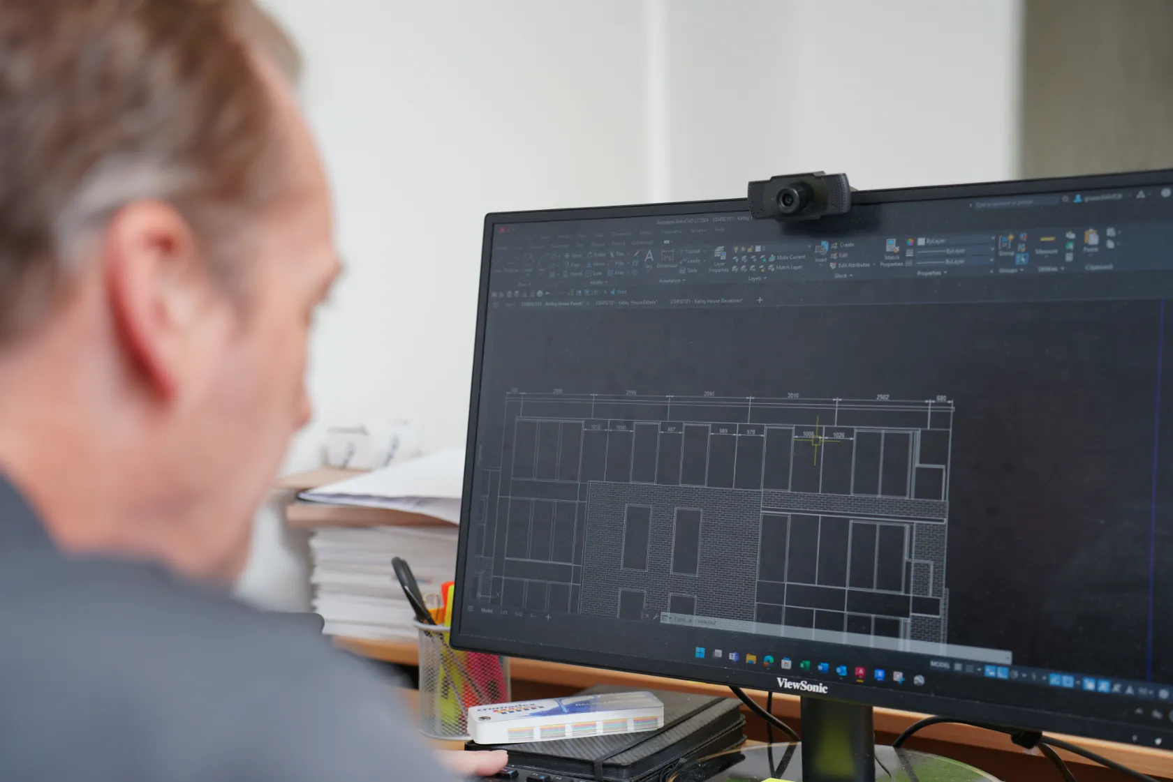 Starfish Construction design engineer reviewing a façade elevation drawing on screen