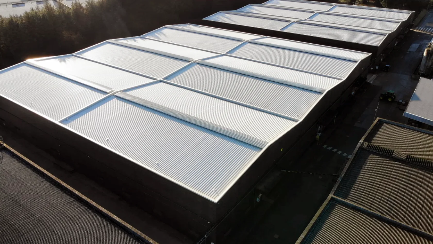 Aerial view of replacement profiled metal roofs on bonded warehouses