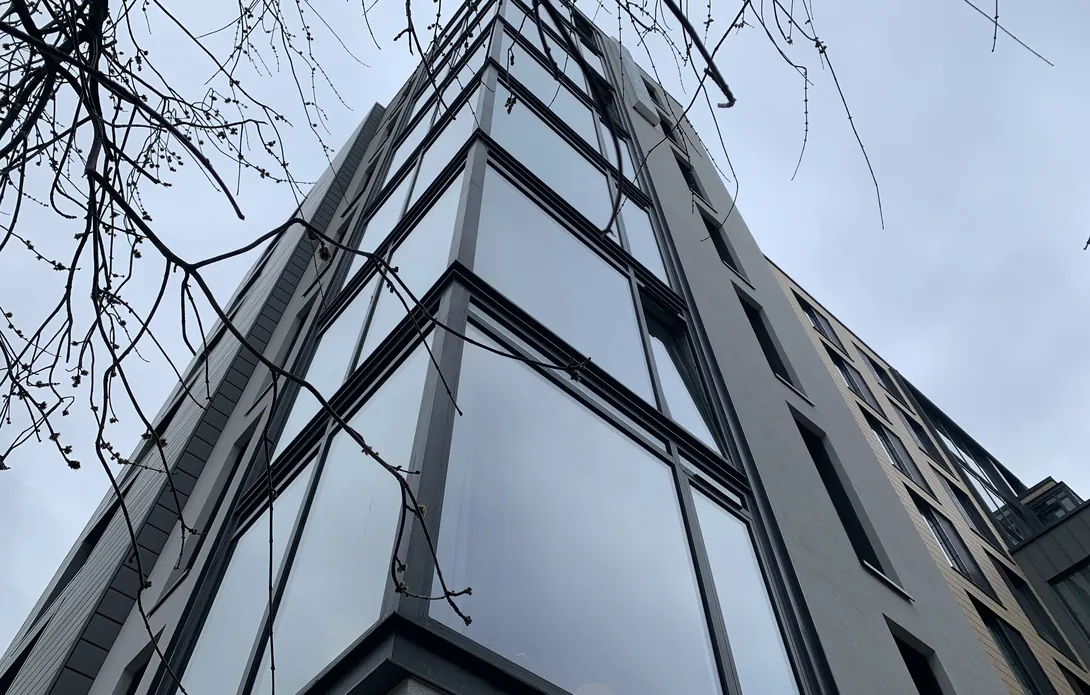Glazed corner of Glassyard with new render to areas without cladding