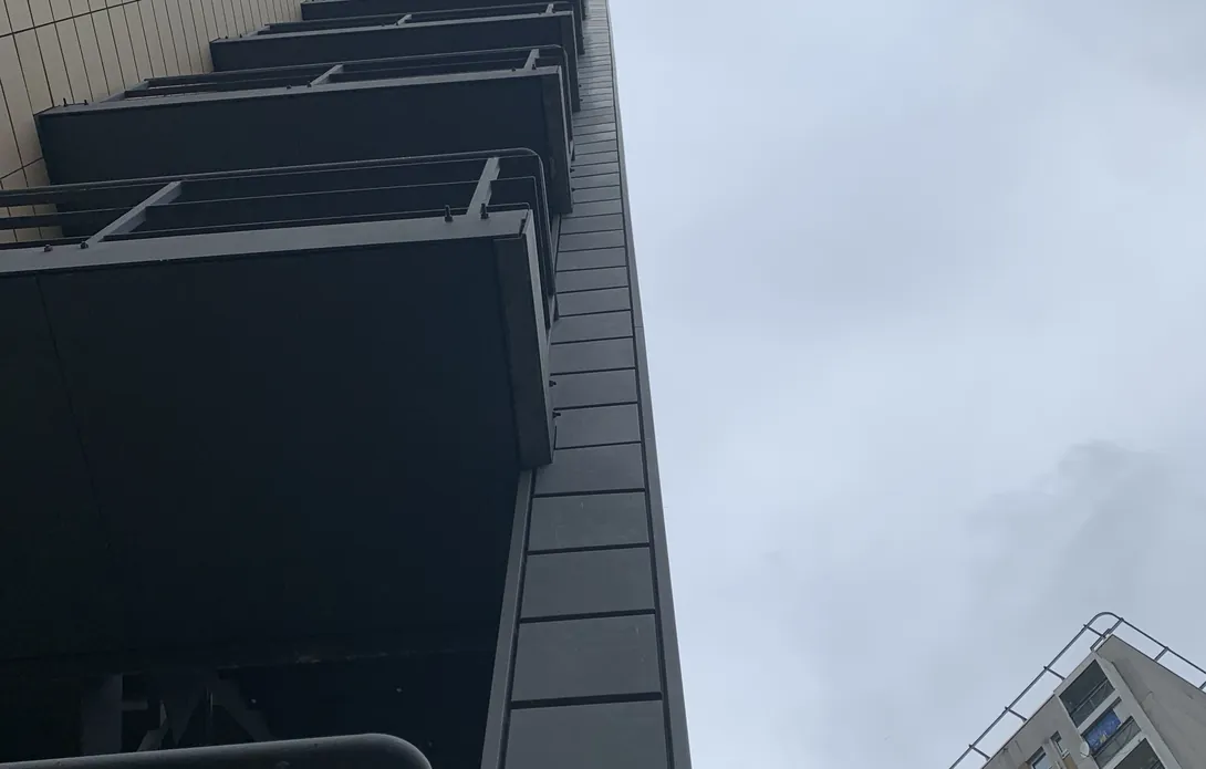 Underside of the balconies with replaced grey zinc cladding