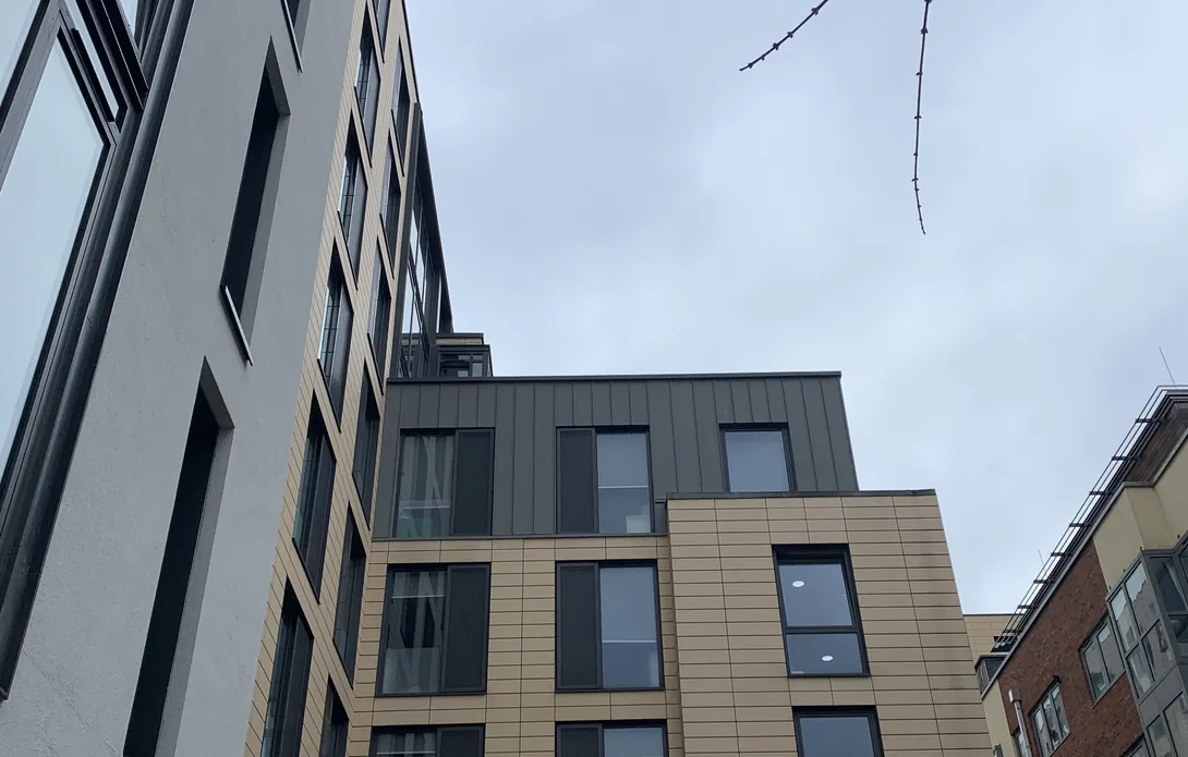 New grey zinc standing seam cladding on the upper storeys at Glassyard