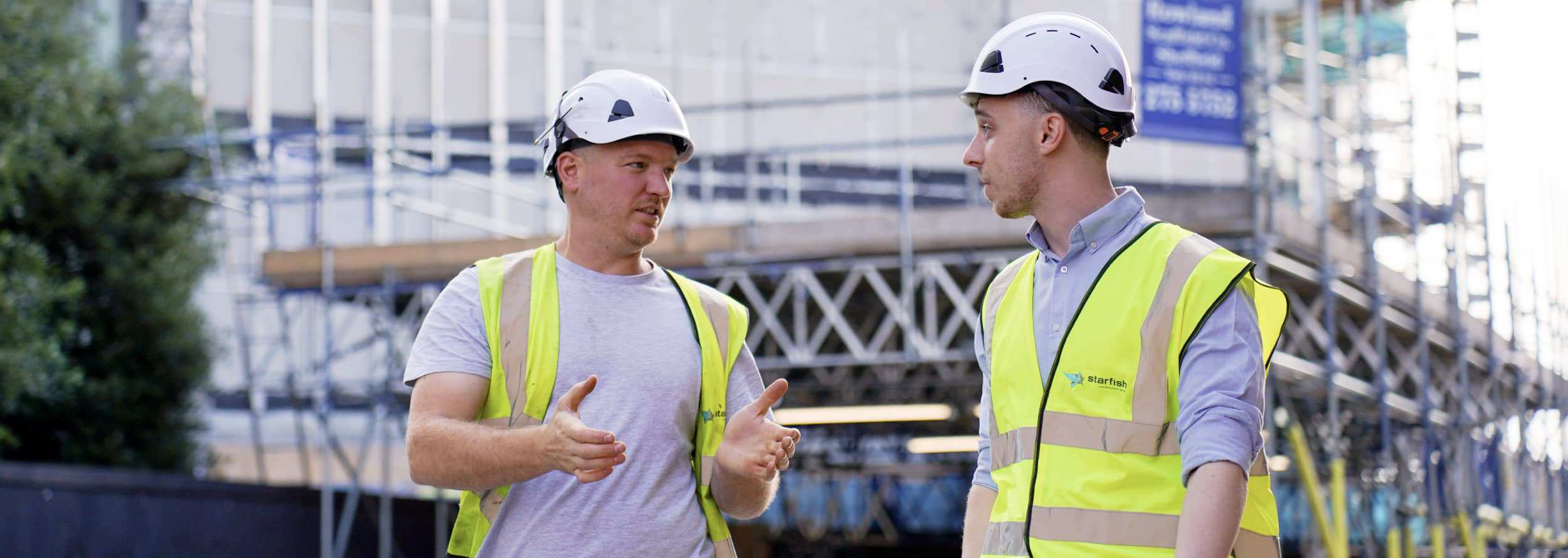 two facade remediation construction workers