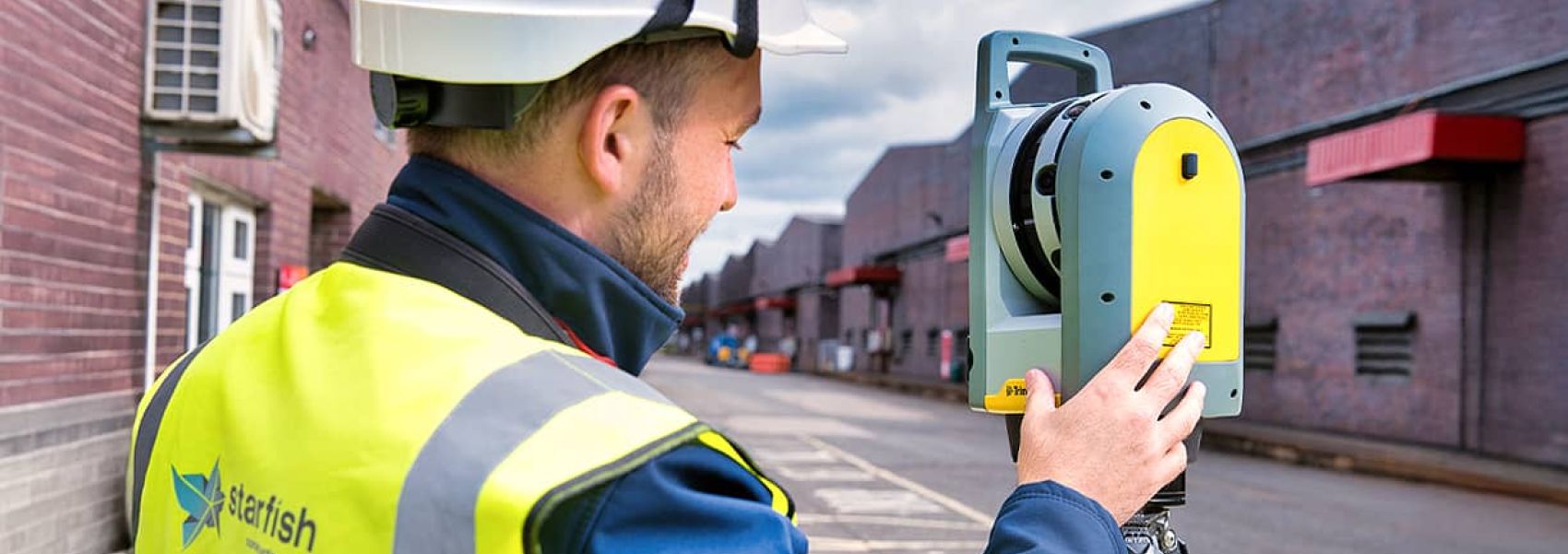 Scaffolding within enclosed work area with work people laying flooring